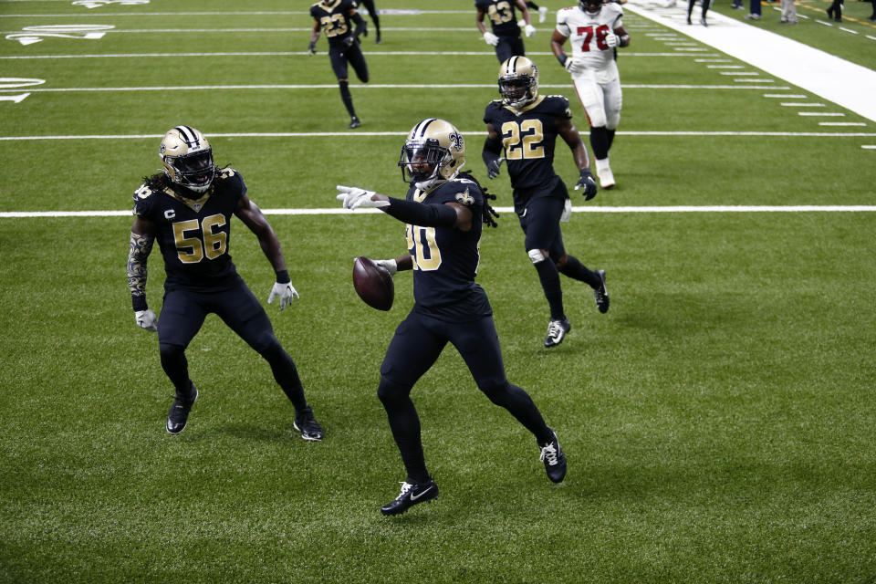 New Orleans Saints cornerback Janoris Jenkins (20) celebrates his pick six with outside linebacker Demario Davis (56) and safety Chauncey Gardner-Johnson (22) in the second half of an NFL football game against the Tampa Bay Buccaneers in New Orleans, Sunday, Sept. 13, 2020. (AP Photo/Brett Duke)