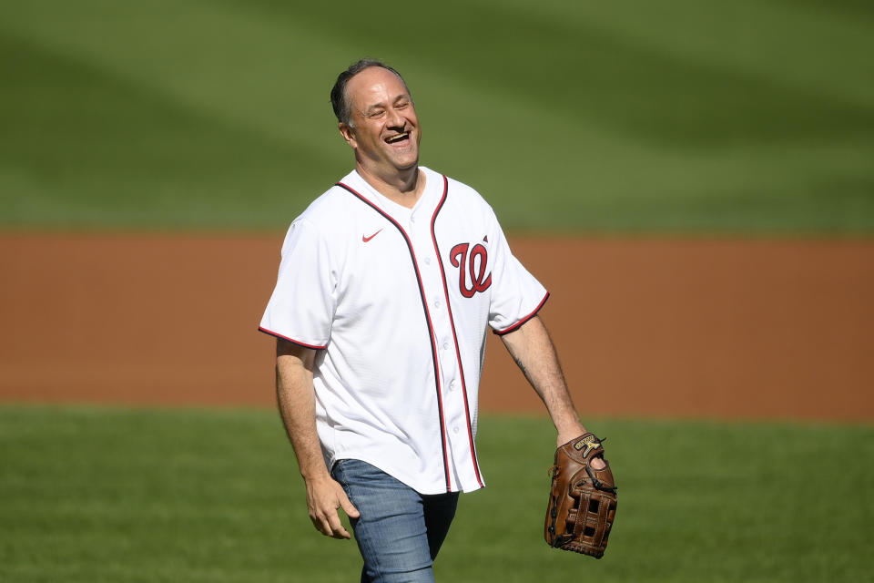 FILE - Doug Emhoff, second gentleman of the United States, reacts after he threw out the ceremonial first pitch before a baseball game between the Washington Nationals and the Colorado Rockies, on Sept. 18, 2021, in Washington. (AP Photo/Nick Wass, File)