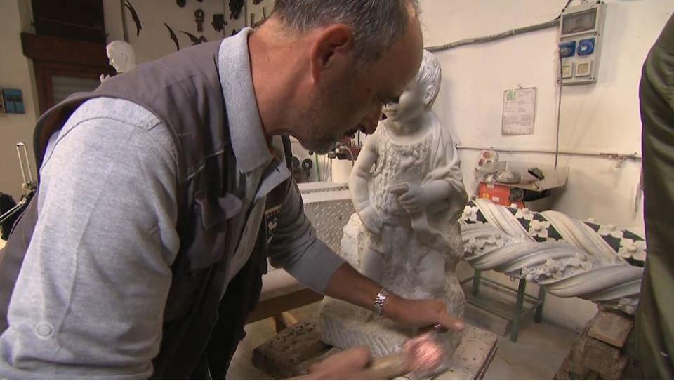 Sculptor Lorenzo Calcinai works on a marble sculpture   in the workshop of the Florence Cathedral, in Florence, Italy. / Credit: CBS News