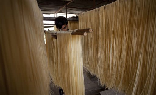 A man carries noodles prepared for Ramadan in Rawalpindi, Pakistan on Thursday, July 19, 2012. Muslims throughout the world are preparing to celebrate the holy fasting month of Ramadan, when they refrain from eating, drinking, and smoking from dawn to dusk. (AP Photo/B.K. Bangash)