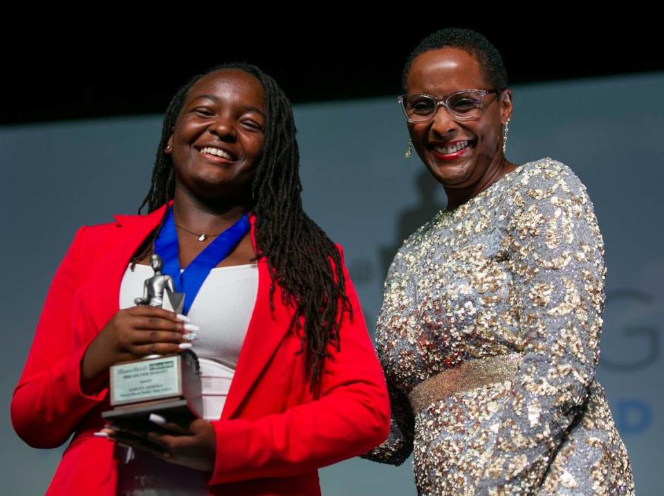 Ashley Adirika, the Miami-Dade Silver Knight Award winner in Speech from Miami Beach Senior High School, is congratulated by Monica Richardson, executive editor of the Miami Herald/el Nuevo Herald, after receiving her award Thursday, May 26, during the Miami Herald & el Nuevo Herald 64th Annual Silver Knight Award Ceremony at the James L. Knight Center in downtown Miami.