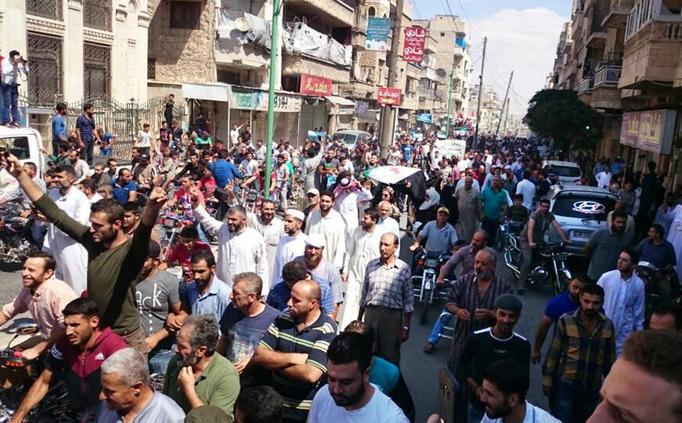 This image courtesy of Wissam Zarqa, an activist and resident of Idlib, shows protesters holding Syrian revolution flags and chanting, in Maaret al-Numan, a town in Idlib province, Syria, Friday, Sept 7, 2018. The rallies were a day of protests against Syrian President Bashar Assad and his troops' imminent offensive against Idlib, the last bastion of rebels in Syria. The Friday rallies came as Presidents of Iran, Turkey and Russia are meeting in Tehran to discuss the war in Syria. The summit may determine whether diplomacy halts any military action in Idlib and its surrounding areas, home to more than 3 million people. Nearly half of the area's residents are already displaced from other parts of Syria and have refused to reconcile with the Syrian government. (Courtesy of Wissam Zarqa via AP)