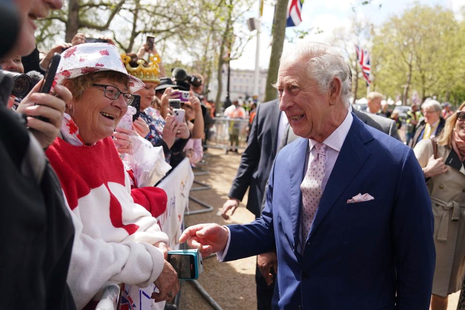 Britain's King Charles III greets well-wishers Friday outside Buckingham Palace in London, a day before his coronation takes place at Westminster Abbey.