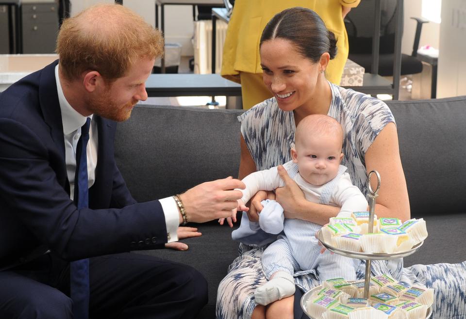 Britain's Duke and Duchess of Sussex, Prince Harry and his wife Meghan hold their baby son Archie as they meet with Archbishop Desmond Tutu (unseen) at the Tutu Legacy Foundation  in Cape Town on September 25, 2019. - The British royal couple are on a 10-day tour of southern Africa -- their first official visit as a family since their son Archie was born in May.