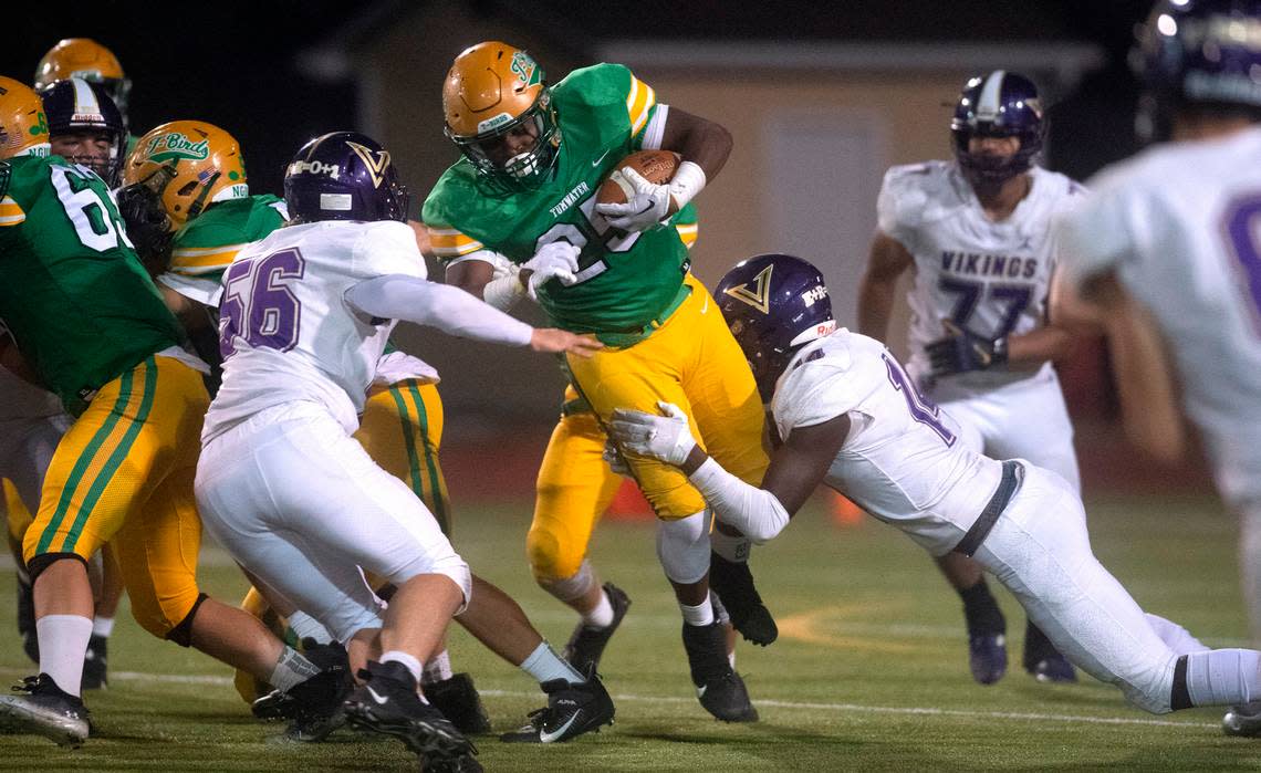 Tumwater running back Carlos Matheney tries to power through North Kitsap linebackers Billy Staley (56) and Ethan Guerra during Friday night’s 2A football game at Tumwater District Stadium in Tumwater, Washington, on Sept. 9, 2022. Tumwater won the game, 8-6.