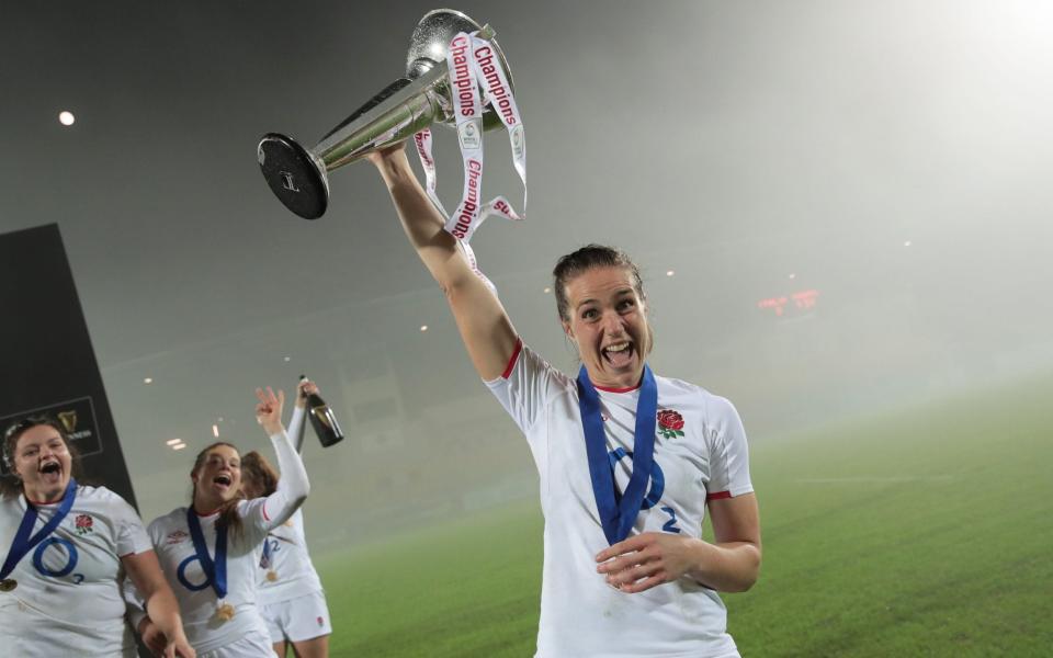 Emily Scarratt of England celebrates with the 6 Nations trophy after winning the Grand Slam during the Women's Six Nations match between Italy and England  - Getty Images