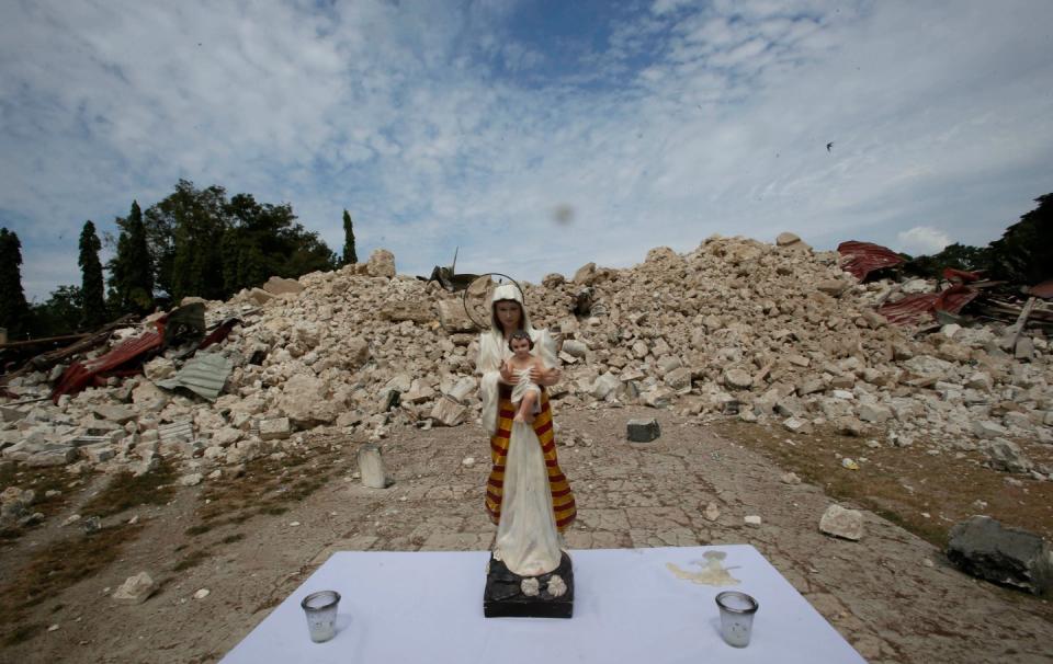 FILE PHOTO: An image of Virgin Mary and baby Jesus is seen in front of the collapsed centuries-old Our Lady of Light church in Loon, Bohol, a day after an earthquake hit central Philippines October 16, 2013. (Source: REUTERS/Erik De Castro)