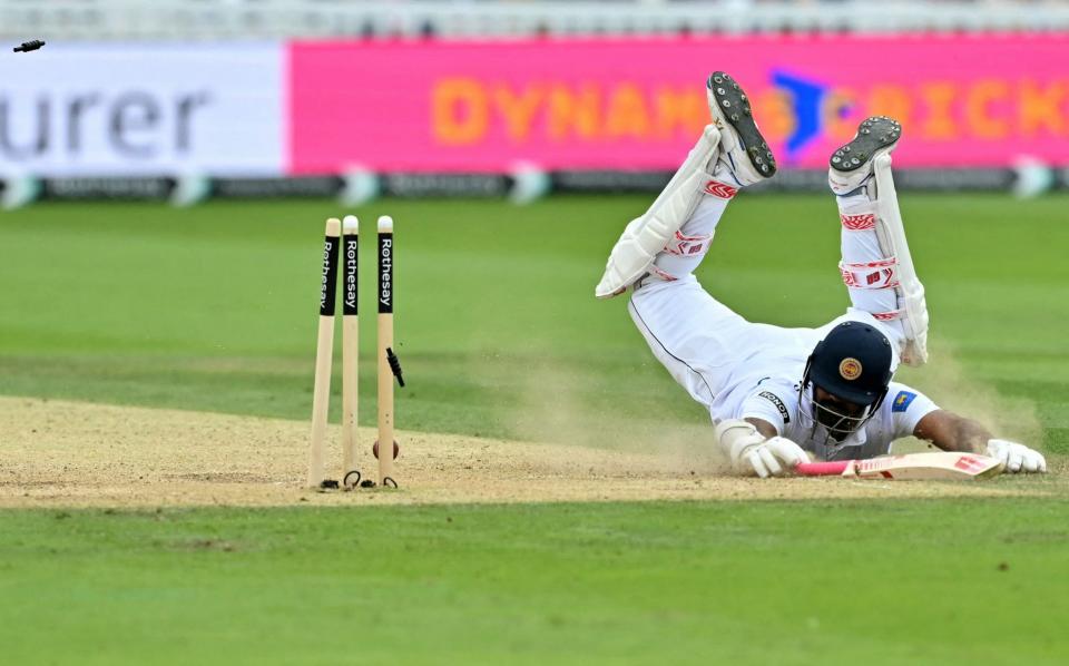 Lahiru Kumara's stumps are sent flying as he dives in vain to make his ground