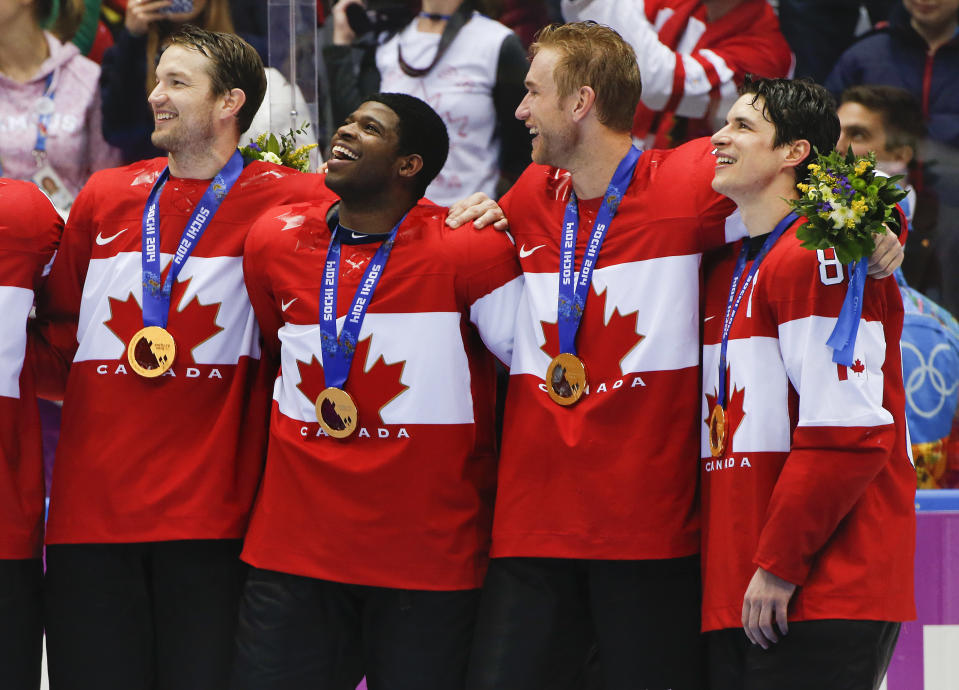 Canada forward Sidney Crosby, far right, stands with teammates for the Canadian national anthem after beating Sweden 3-0 in the men's gold medal ice hockey game at the 2014 Winter Olympics, Sunday, Feb. 23, 2014, in Sochi, Russia. (AP Photo/Julio Cortez)