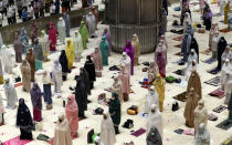 Indonesian Muslims pray spaced apart as they practice social distancing to curb the spread of the new coronavirus during an evening prayer called "tarawih" marking the first eve of the holy fasting month of Ramadan at Istiqlal Mosque in Jakarta, Indonesia. Monday, April 12, 2021. During Ramadan, the holiest month in Islamic calendar, Muslims refrain from eating, drinking, smoking and sex from dawn to dusk. (AP Photo/ Achmad Ibrahim)