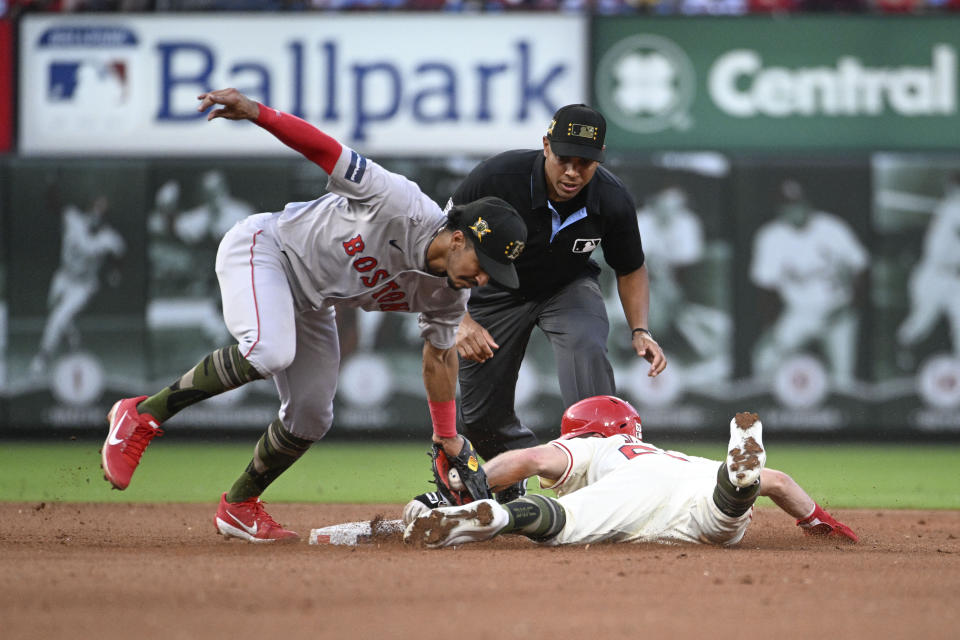 St. Louis Cardinals' Michael Siani, right, is tagged out by Boston Red Sox shortstop David Hamilton, left, on an attempted steal, as umpire Jeremie Rehak, center, watches during the fifth inning of a baseball game Saturday, May 18, 2024, in St. Louis. (AP Photo/Joe Puetz)