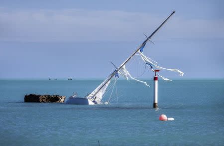 A sailboat lists to one side after Hurricane Gonzalo passed through in Sandys Parish, western Bermuda, October 18, 2014. REUTERS/Nicola Muirhead