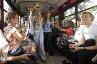 Models wear creations onboard a tram as part of the Missoni Spring-Summer 2020 collection, unveiled during the fashion week, in Milan, Italy, Thursday, Sept. 19, 2019. (AP Photo/Luca Bruno)