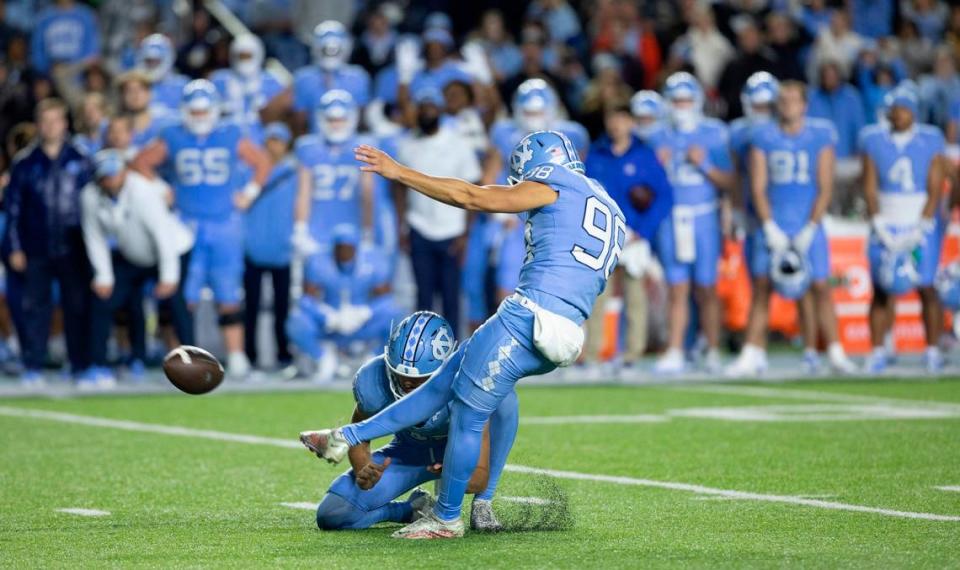 North Carolina kicker Noah Burnette (98) boots a 43-yard field goal to tie Duke 36-36 at the end of regulation, forcing overtime on Saturday, Nov. 11, 2023 at Kenan Stadium in Chapel Hill, N.C.