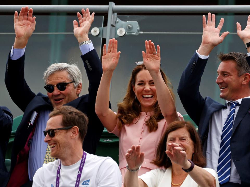 Michael Middleton and Kate Middleton take part in a crowd wave.