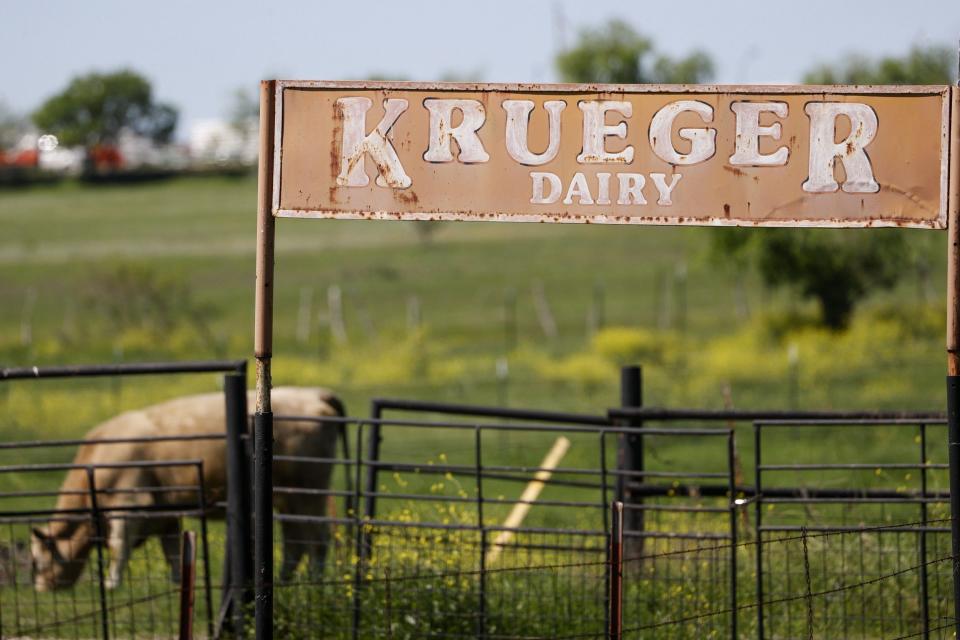 A sign stands on a fence a cattle farm in Austin, Texas