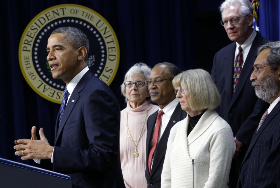 President Barack Obama gestures as he speaks in the Eisenhower Executive Office Building, on the White House campus in Washington, Wednesday, Nov. 28, 2012, about how middle class Americans would see their taxes go up if Congress fails to act to extend the middle class tax cuts. The president said he believes that members of both parties can reach a framework on a debt-cutting deal before Christmas. The presidential seal in on the wall in the background. (AP Photo/Pablo Martinez Monsivais)