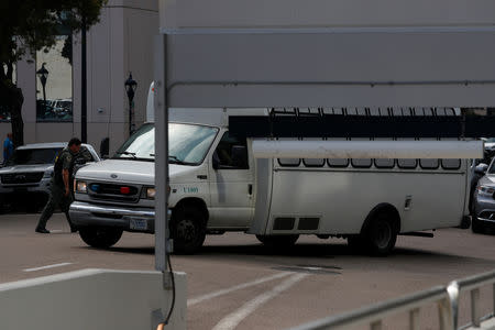 A vehicle, carrying asylum seekers brought from Tijuana, Mexico to the United States for their immigration hearing, arrives at a court in San Diego, California, U.S., March 19, 2019. REUTERS/ Mike Blake