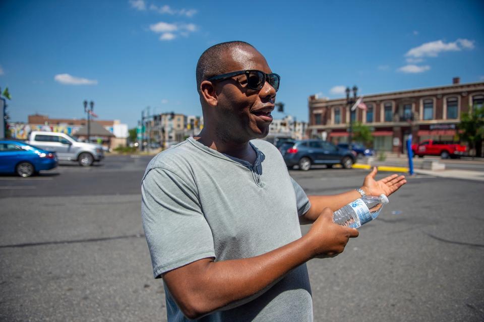 As temperatures soared to nearly 100 degrees, Framingham resident Charley Bokor handed out water and feminine hygiene products in downtown Framingham, Aug. 4, 2022.