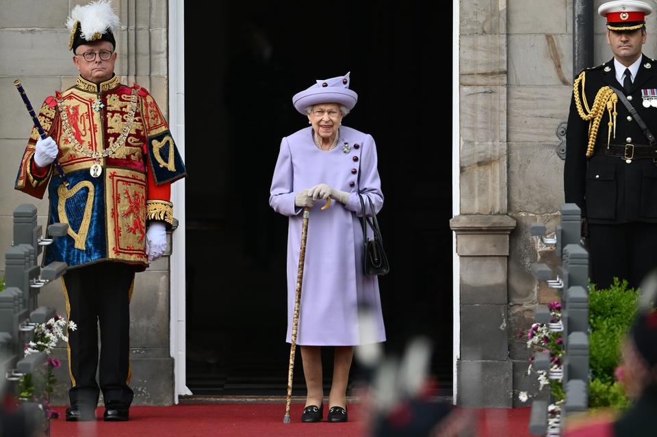 Queen Elizabeth II (C) attends an Armed Forces Act of Loyalty Parade at the Palace of Holyroodhouse