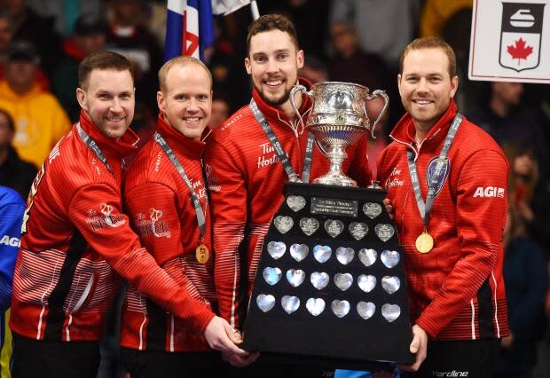 Team Newfoundland and Labrador skip Brad Gushue, left to right, third Mark Nichols, second Brett Gallant and lead Geoff Walker hold the Brier Tankard trophy after defeating Team Alberta in the 2020 Brier curling final.