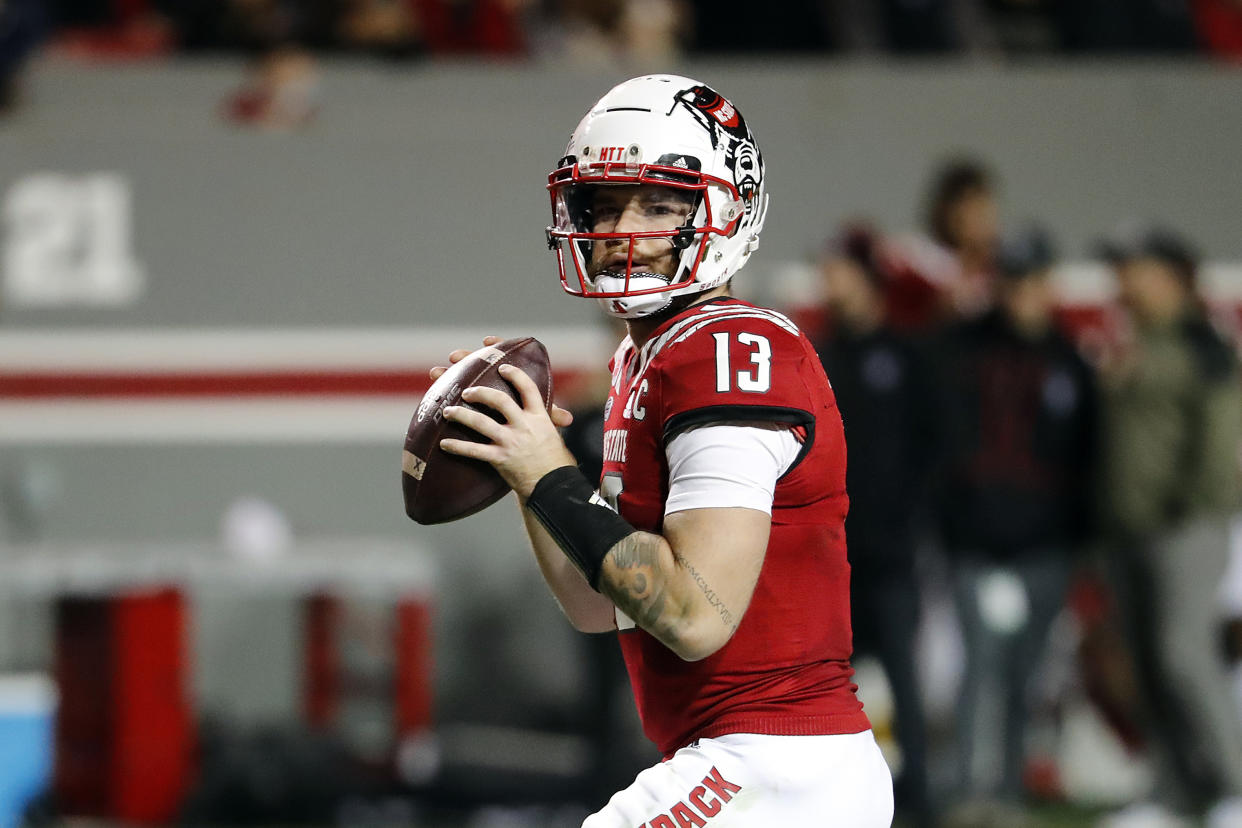 North Carolina State's Devin Leary (13) gets ready to pass the ball against Syracuse during the second half of an NCAA college football game in Raleigh, N.C., Saturday, Nov. 20, 2021. (AP Photo/Karl B DeBlaker)