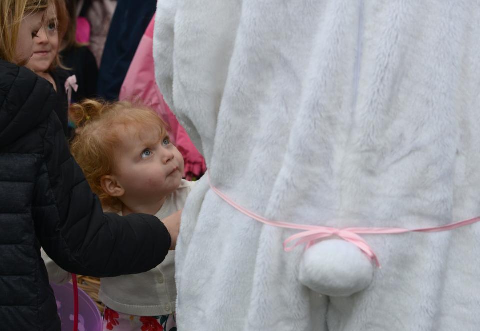 Two-year-old Morianna Souza got her first look at the Easter Bunny handing out chocolate eggs at the Kate Gould Park in Chatham where the town's annual Easter egg hunt returned last year after a pandemic pause the last two years.