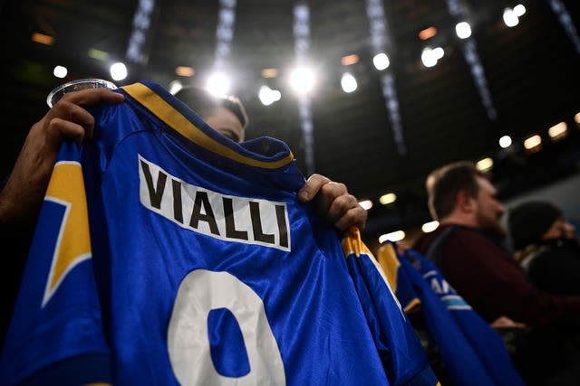 A fan holds a jersey with the name of former Juventus striker Gianluca Vialli