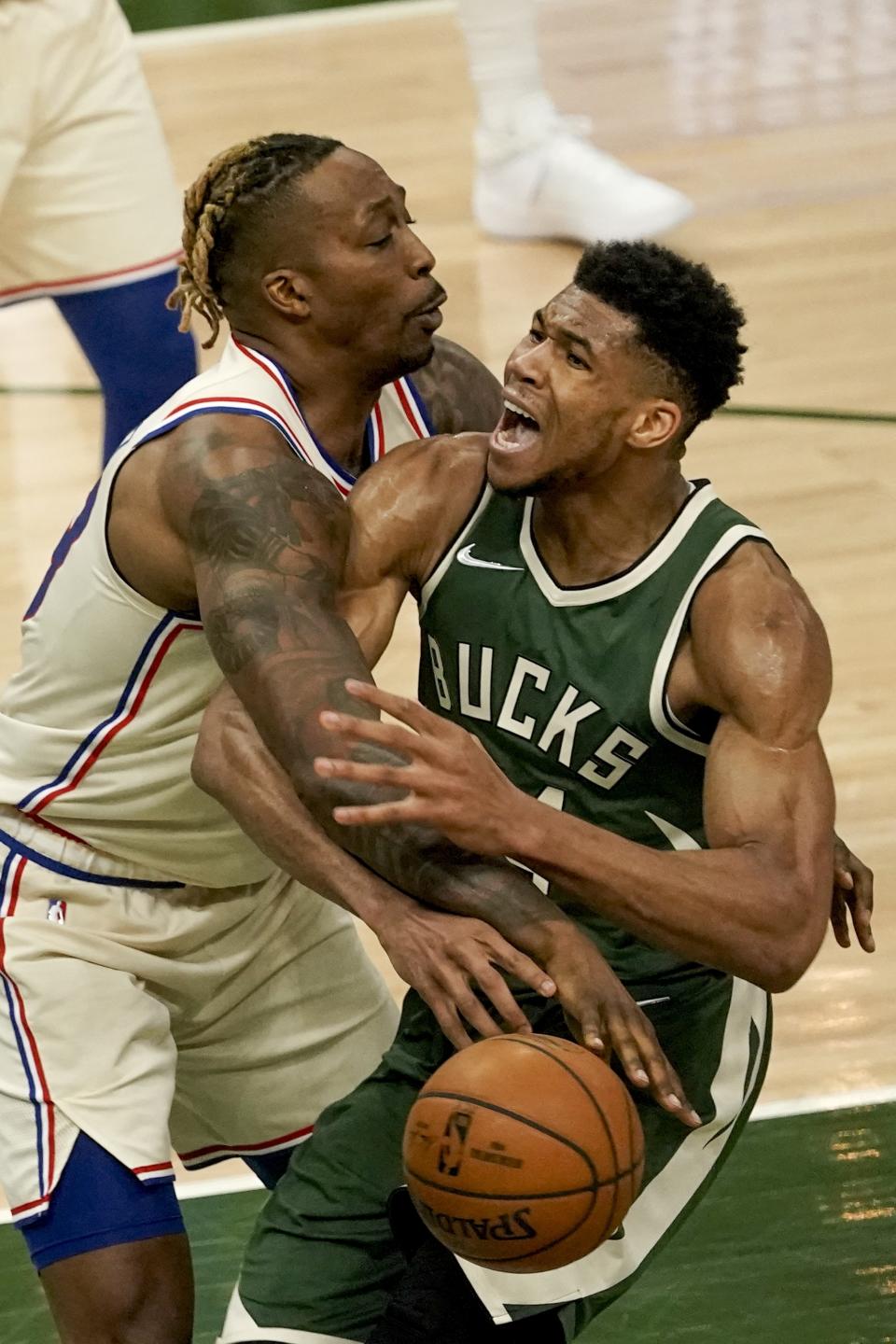 Philadelphia 76ers' Dwight Howard fouls Milwaukee Bucks' Giannis Antetokounmpo during the second half of an NBA basketball game Saturday, April 24, 2021, in Milwaukee. (AP Photo/Morry Gash)