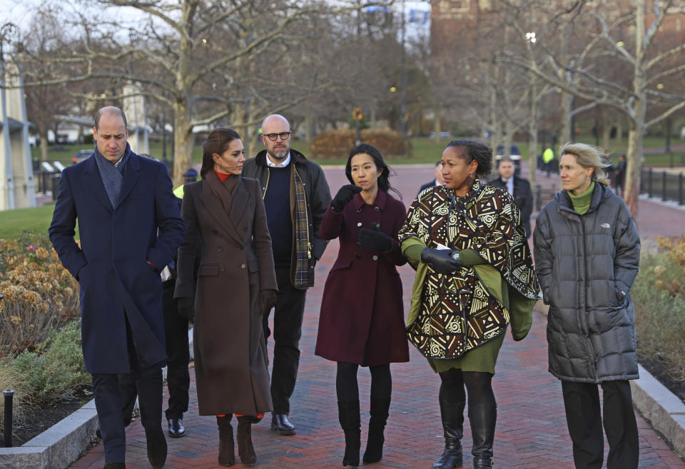 Britain's Prince William, left, and Kate, Princess of Wales, traveled to East Boston to see the changing face of Boston's shoreline as the city contends with rising sea levels, Thursday, Dec. 1, 2022. They walk with City of Boston Mayor Michelle Wu, center, Rev. Mariama White-Hammond, second right, and Lisa Wieland, right. The royal couple’s visit comes as they look to foster new ways to address climate change. (David L. Ryan/The Boston Globe via AP, Pool)