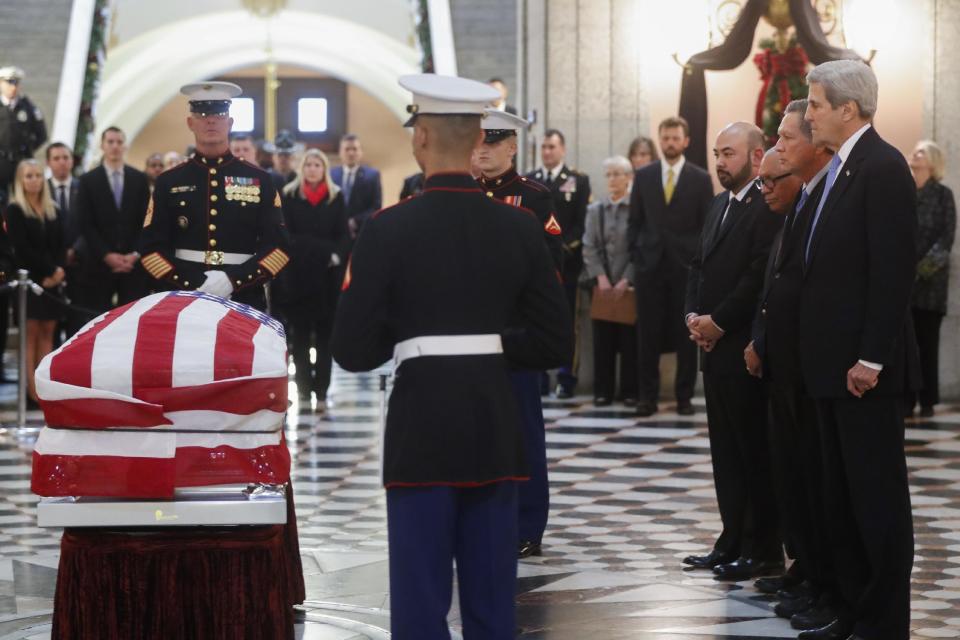 U.S. Secretary of State John Kerry, right, and Ohio Gov. John Kasich, second from right, view the casket of John Glenn as he lies in honor, Friday, Dec. 16, 2016, in Columbus, Ohio. Glenn's home state and the nation began saying goodbye to the famed astronaut who died last week at the age of 95. (AP Photo/John Minchillo)