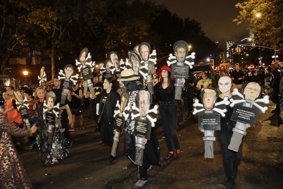 Revelers march during the Greenwich Village Halloween Parade, Thursday, Oct. 31, 2019, in New York. (AP Photo/Frank Franklin II)