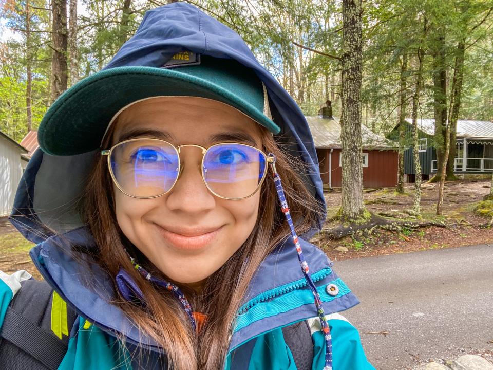 The author in front of the cabins in the woods