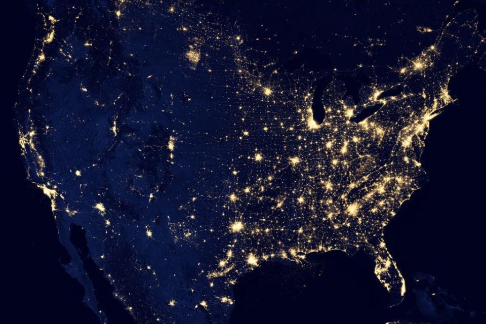 Map of the US at night lit up.