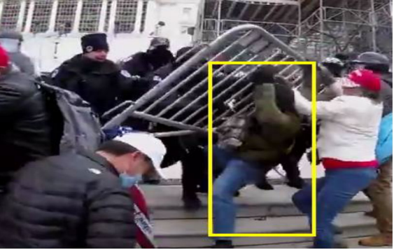 Footage shows a subject struggling with officers over the barricade in an attempt to breach the police barricade (US DOJ).