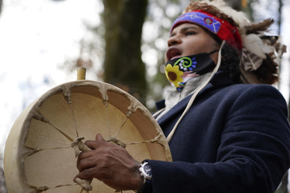 Larry Fisher, chief sachem of the Mattakeeset Massachuset tribe, sings and drums a traditional song honoring their land and ancestry at Titicut Indian Reservation, Friday, Nov. 27, 2020, in Bridgewater, Mass. A rift has been widening between Native American groups in New England over a federal reservation south of Boston where one tribe is planning to build a $1 billion casino. The Mattakeeset Massachuset tribe contend the Mashpee Wampanoag tribe doesn't have exclusive claim to the lands under their planned First Light casino in the city of Taunton, as they've argued for years. (AP Photo/Elise Amendola)