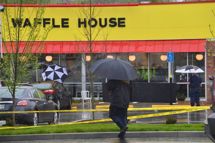 Law enforcement officials stand outside a Waffle House where four people were killed and two wounded on April 22, 2018, in Nashville.