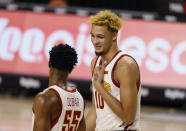 Iowa State forward Xavier Foster, right, jokes with guard Darlinstone Dubar, left, during a timeout in the second half of an NCAA college basketball game against Arkansas-Pine Bluff, Sunday, Nov. 29, 2020, in Ames, Iowa. (AP Photo/Matthew Putney)