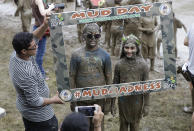 <p>Kids pose for a photo during Mud Day at the Nankin Mills Park, July 11, 2017 in Westland, Mich. (Photo: Carlos Osorio/AP) </p>