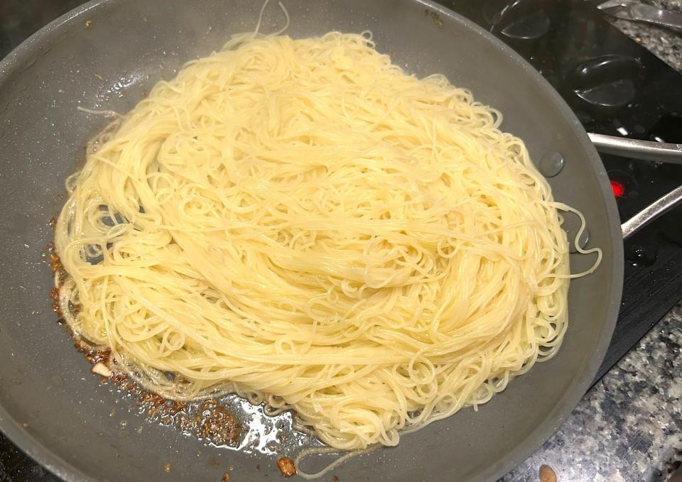 Adding pasta to pan for Gordon Ramsay's 10-minute scampi