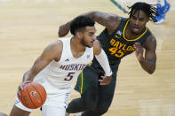 Washington's Jamal Bey (5) drives around Baylor's Davion Mitchell (45) during the second half of an NCAA college basketball game Sunday, Nov. 29, 2020, in Las Vegas. (AP Photo/John Locher)