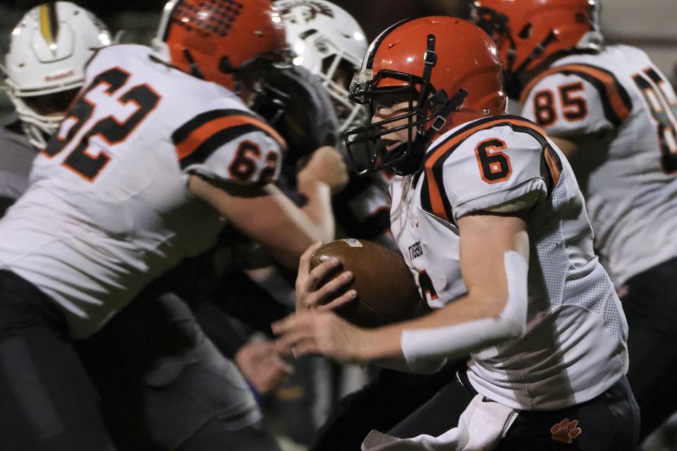 Versailles Carson Bey (6) runs with the ball during a high school football playoff game between the Versailles Tigers at the Roger Bacon Spartans in Cincinnati, Ohio on Saturday, Oct. 31, 2020. Roger Bacon defeated Versailles 31-28 to advance to the next round of the playoffs.