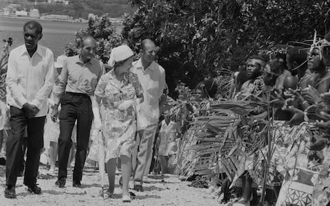 Queen Elizabeth II and Prince Philip were greeted by men in traditional dress on their visit to Port Vila, Vanuatu, in 1974 - Credit: Hulton Royals Collection/McCabe