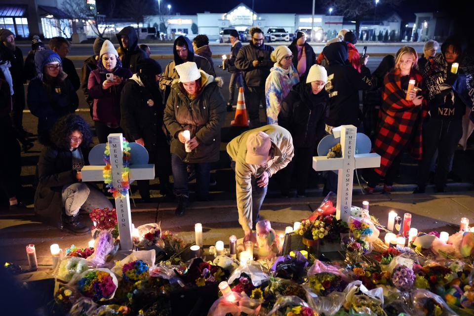 People visit a makeshift memorial near the Club Q nightclub in Colorado Springs, Colo.