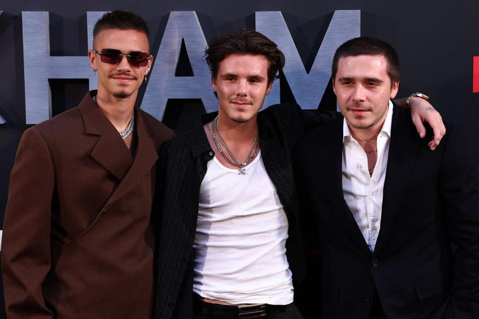 Cruz Beckham (centre) pictured with brothers Romeo (L) and Brooklyn (R) (AFP via Getty Images)