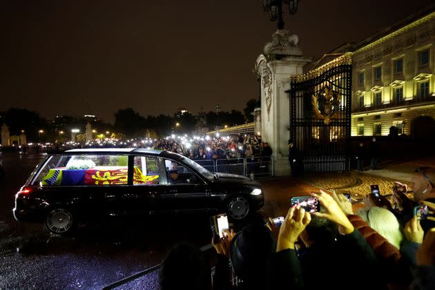 People watch the hearse carrying the coffin of Britain's Queen Elizabeth on Sep. 13. (Photo: ANDREW BOYERS via REUTERS)