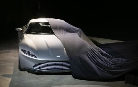 An Aston Martin DB10 car is unveiled on stage during an event to mark the start of production for the new James Bond film "Spectre", at Pinewood Studios in Iver Heath, southern England December 4, 2014. REUTERS/Stefan Wermuth
