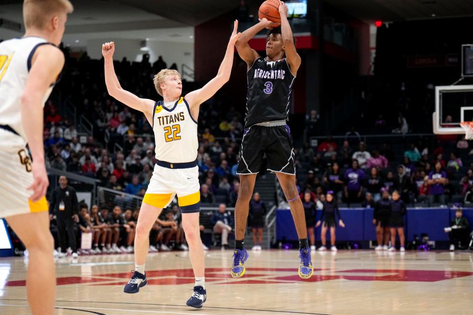 Ottawa-Glandorf's Colin White, left, an Ohio State signee and Mr. Basketball finalist, defends a 3-point attempt from former Africentric star Dailyn Swain during a Division III state semifinal on March 18, 2023.