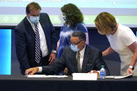 Mississippi State Flag Commission Chairman Rueben Anderson, seated, reviews the results of the commission vote on the flag to be placed on the November ballot during a meeting at the Two Mississippi Museums in Jackson, Miss., Wednesday, Sept. 2, 2020. The New Magnolia Flag, is now known as the "In God We Trust Flag" as per a vote by the commission and will be on the ballot in the fall.3(AP Photo/Rogelio V. Solis)