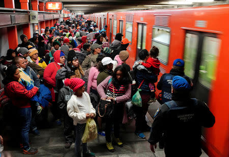 Migrants prepare to get into a train at an underground station during their journey towards the United States, in Mexico City, Mexico, January 31, 2019. REUTERS/Alexandre Meneghini